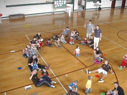 Image courtesy of Paula Scraba: Elementary school students practice motor skills, like throwing and catching, with St. Bonaventure students.