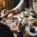 Two people hold hands getting coffee