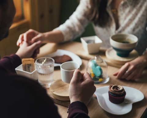 Two people hold hands getting coffee